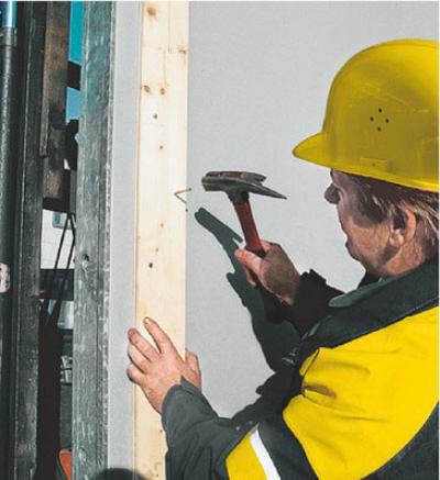 Worker nails into wall formwork Framax Xlife