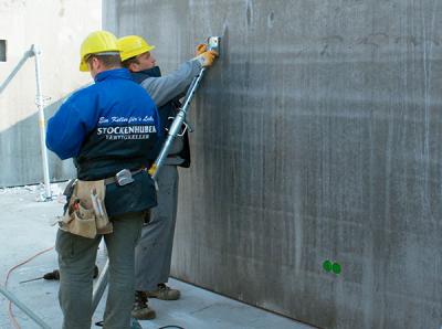 workers installing struts on precast member