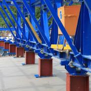 The composite forming carriage is designed to cope with the higher loads resulting from the large and non-uniform distances between the roller-trestle bearing supports.