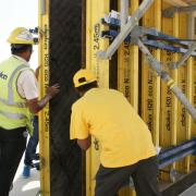 Doka Qatar Formwork Instructor guides workers on how to safely lift Large-area formwork Top 50 panel before casting. Photo: Doka