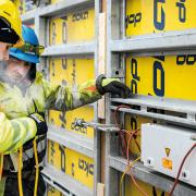 Two people in front of wall formwork